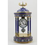 Decorative cloisonne mantel clock, temple form with a domed top supported on six pillars all in blue