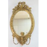 Victorian gilt gesso girandole, oval bevelled glass plate surmounted with a cherub and leaves and