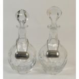 Pair of modern crystal glass decanters, of mallet form, each with conforming stopper and with