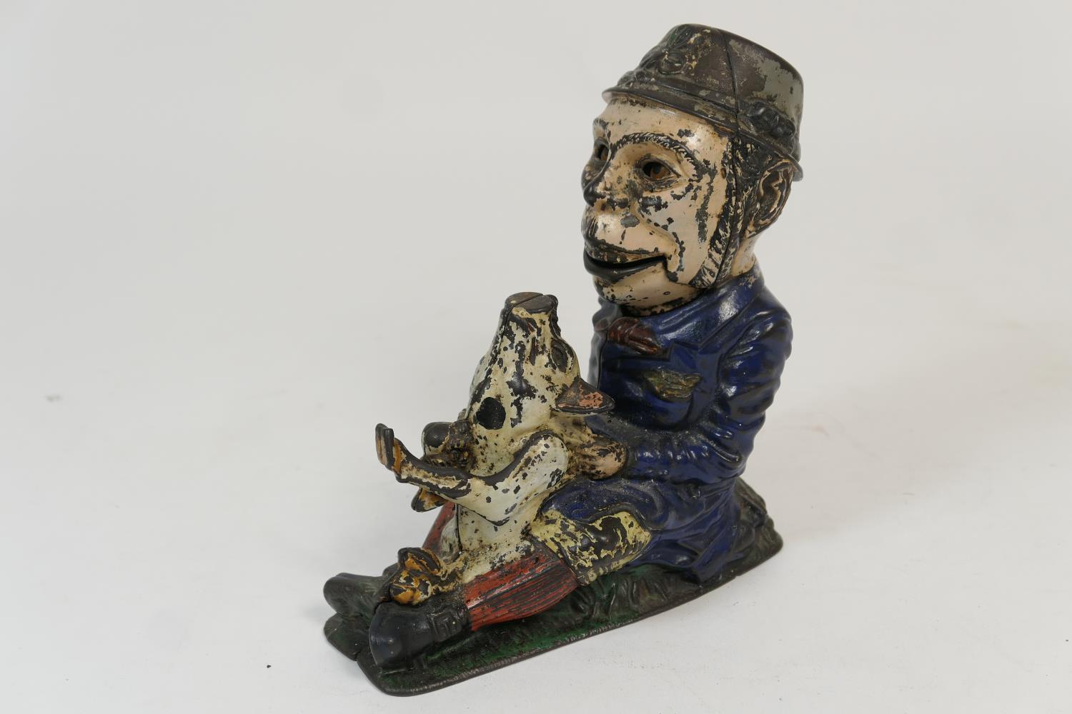 Painted cast iron novelty money box, formed as an Irishman holding a piglet, height 21cm (Viewing is