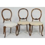 Pair of Victorian walnut balloon back dining chairs, circa 1860-80, with cream fabric stuffover