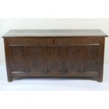 Joined oak coffer, late 17th Century with later carving, having a hinged two plank top over a carved