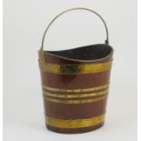Irish mahogany and brass bound peat bucket, circa 1800, oval form with brass swing handle, height