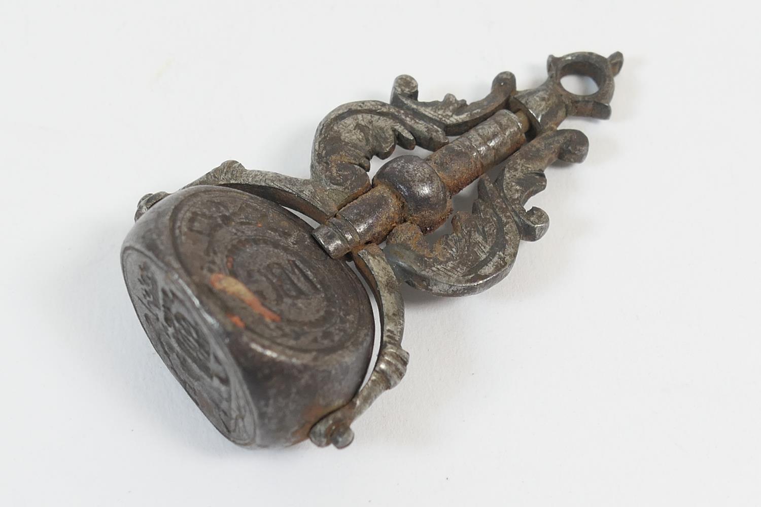 Wrought metal swivelling seal fob, late 17th or early 18th Century, having three seals fixed by a