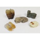 Five Chinese carved jade items including a celadon dog, 7cm; pair of puppies in yellow jade, 5cm;