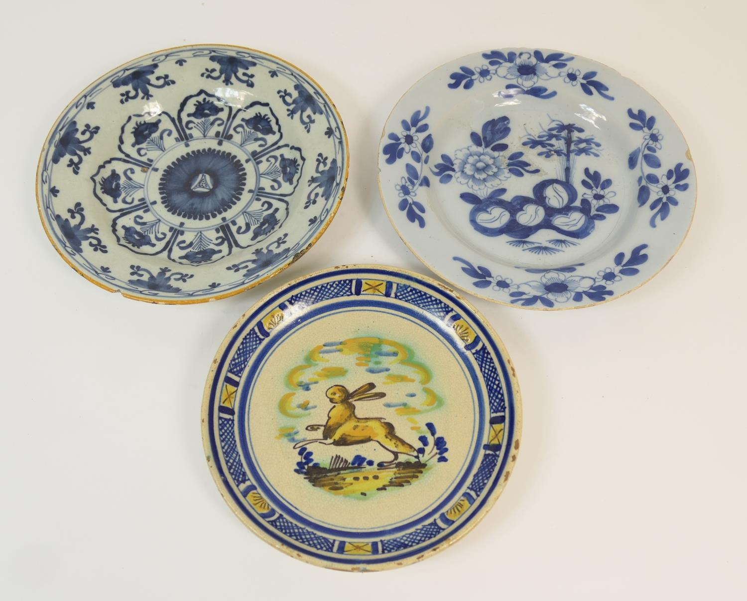 Two Dutch delft blue and white plates, late 18th Century, one decorated with a peony rock pattern,