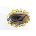 Victorian agate brooch, circa 1870, the oval agate set within an unmarked yellow gold openwork frame
