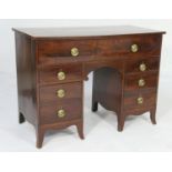 Mahogany kneehole secretaire desk, early 19th Century, having a feathered mahogany pull down upper