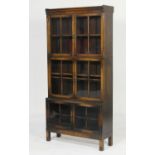 George V oak glazed sectional bookcase, fitted with six doors opening to two shelves, raised on