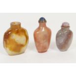 Three Chinese hardstone snuff bottles, including agate bottle with carved lion's mask ring