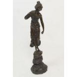 French bronze sculpture of a young girl, standing on a rocky plinth, late 19th Century, mid brown