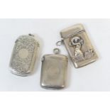 Three silver vesta cases, comprising one of cushion form with scroll engraved decoration and