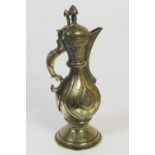 Kashmir brass ewer, late 19th Century, of pear shape with hinged domed cover, worked throughout with