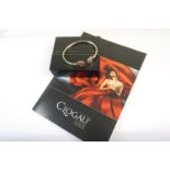 Clogau 9ct gold bangle, circa 2000, of torc form with two discs inspired by a Welsh dragon, 60mm,