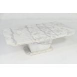 Solid white marble coffee table, the roughly hewn canted rectangular top over a tapered plinth