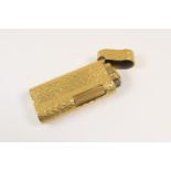 Dunhill gold plated gas lighter, textured finish, numbered C94342, 6.5cm (Viewing is by