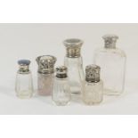 Eight various silver topped clear glass bottles, all early 20th Century, the largest 10cm (Viewing