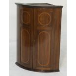 George III mahogany and inlaid hanging bowfront corner cupboard, circa 1790, with a moulded
