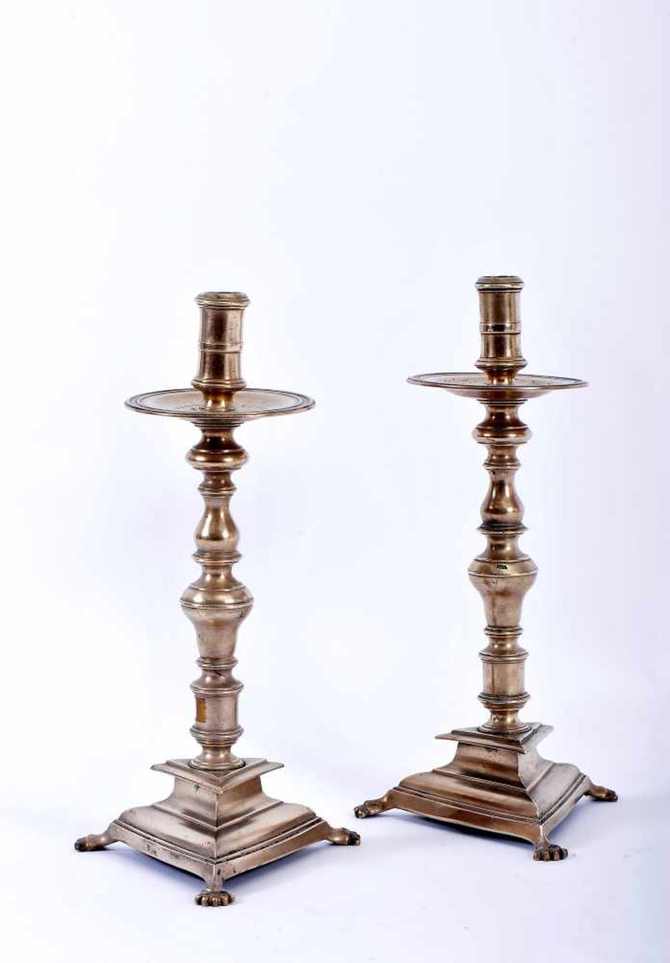 A Pair of Triangular Base Candlesticks with Feet