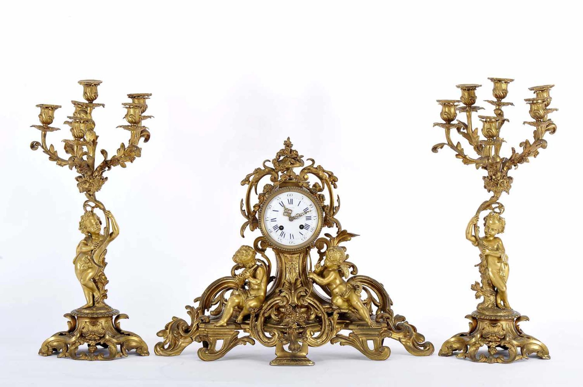 A Garniture - A Table Clock and a pair of six-light Candelabra