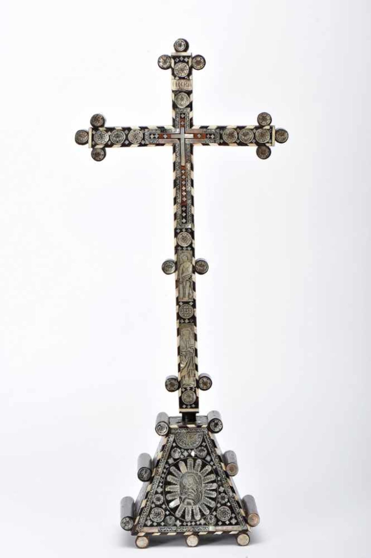 A CrucifixA Crucifix, olive wood coated with engraved mother-of-pearl plaques with backgrounds