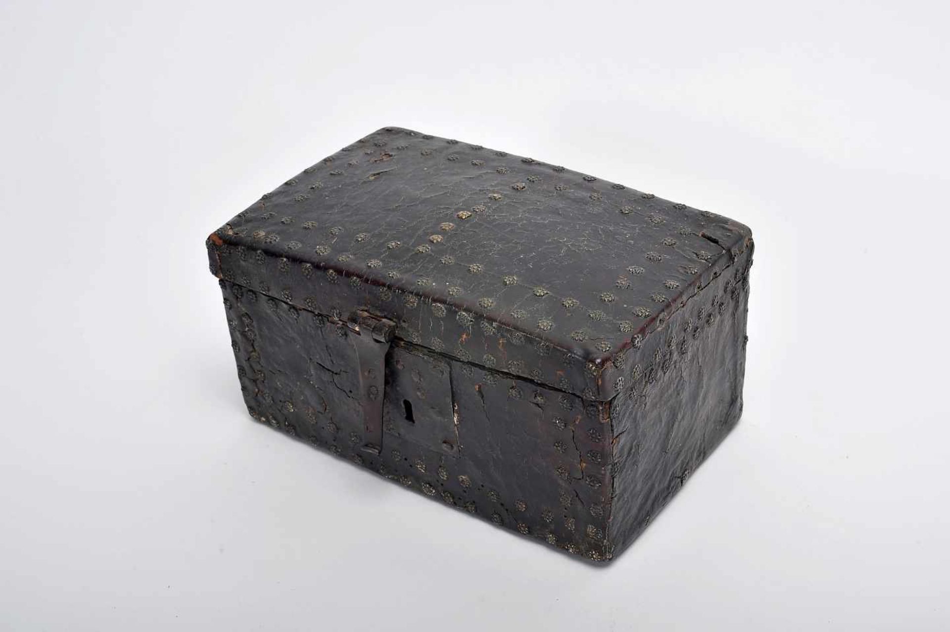 A ChestA Chest, wood entirely coated with leather with studs en relief "Flowers of eight petals",