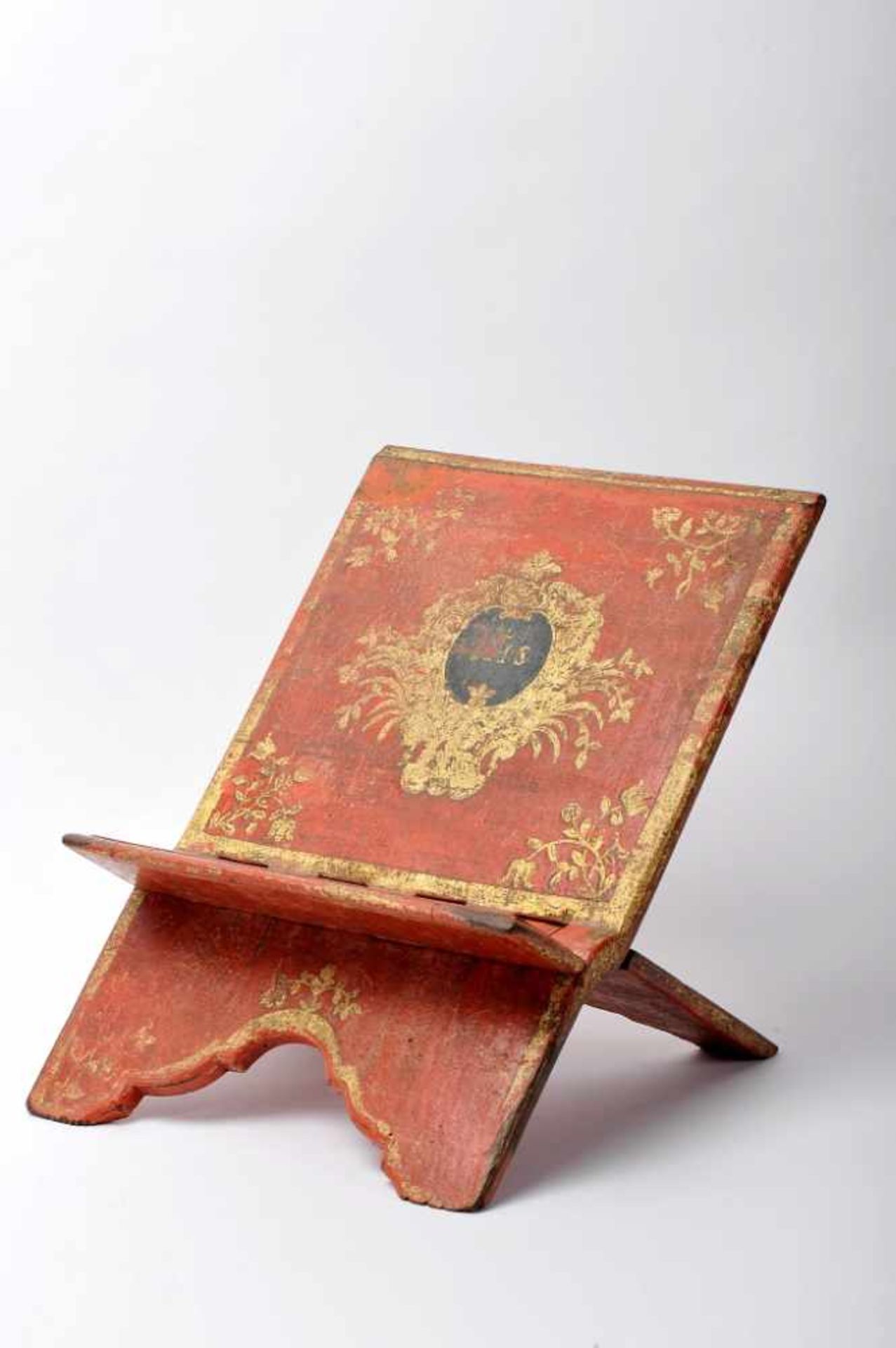 A Missal StandA Missal Stand, red painted wood with gilt and black decoration with the insignia of