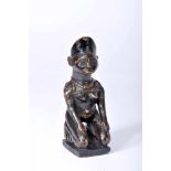 A Yombé kneeling African female figureA Yombé kneeling African female figure, darkened wood Yombe