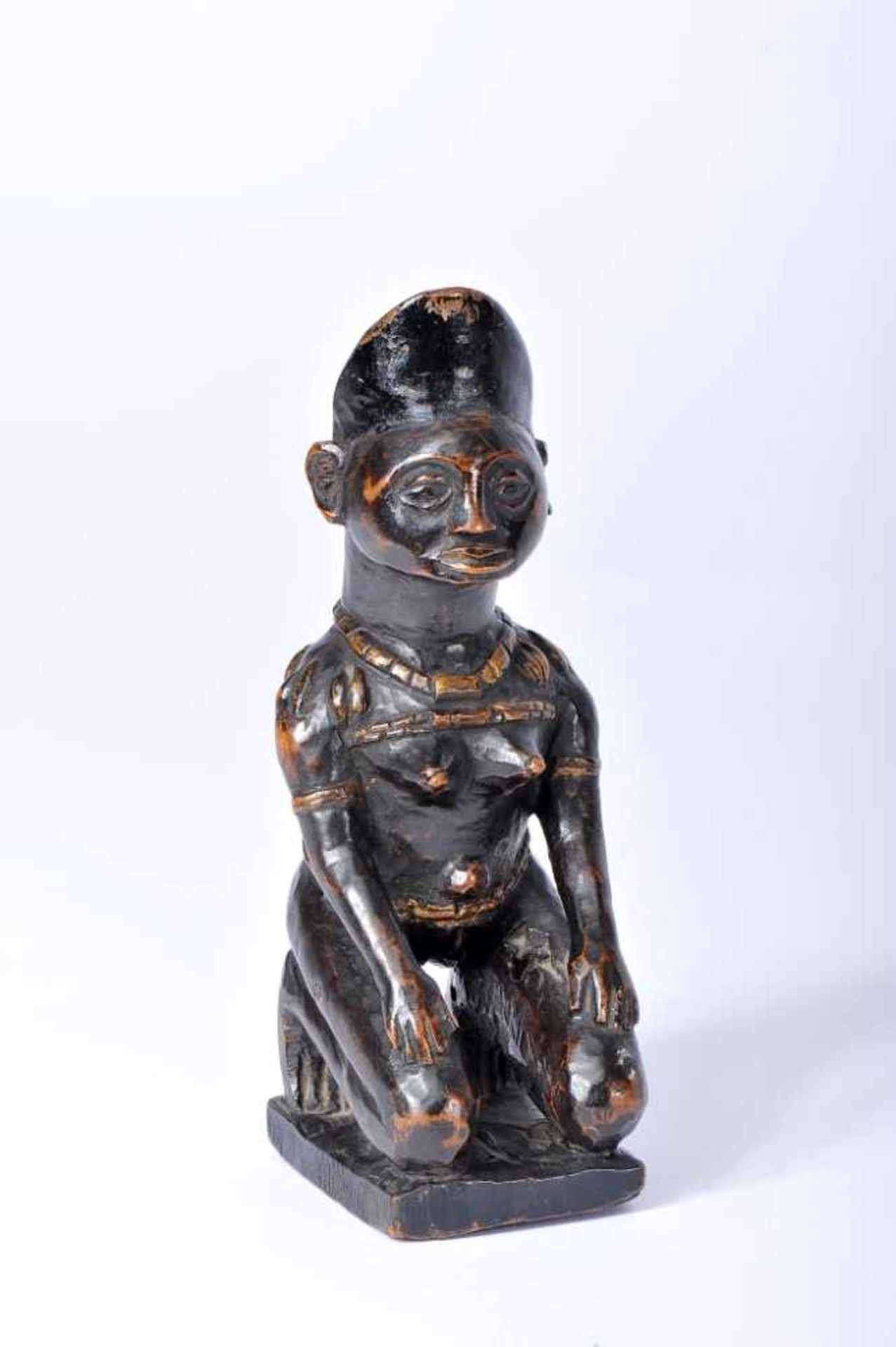 A Yombé kneeling African female figureA Yombé kneeling African female figure, darkened wood Yombe