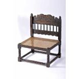 A Low-seat ChairA Low-seat Chair, Dutch colonial, carved sissoo "Grotesque masks and plant