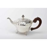 A Tripod TeapotA Tripod Teapot, rocaille, silver, gadrooned decoration en relief "Shell motifs",