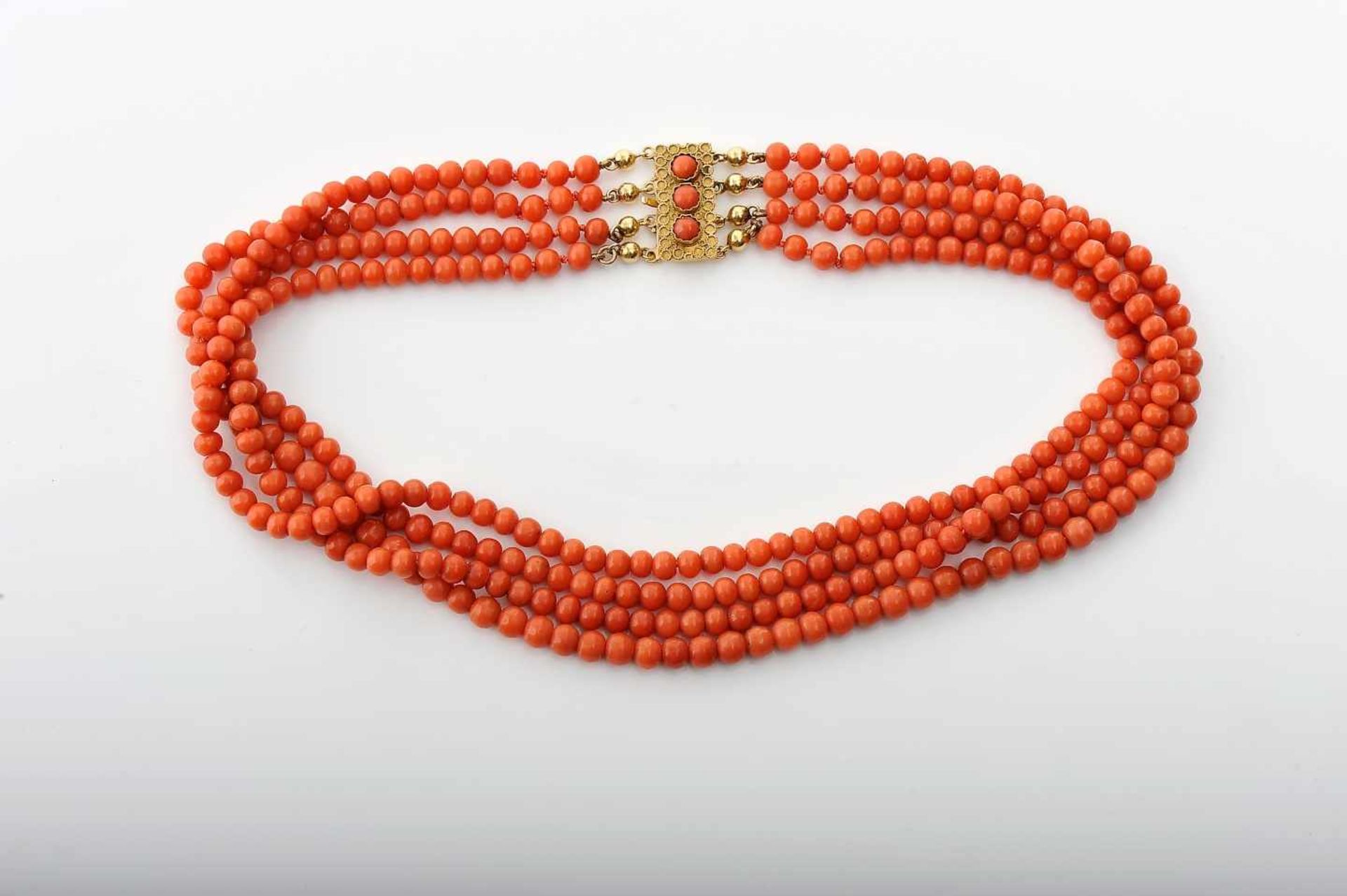 A NecklaceA Necklace, four strings of Mediterranean coral beads, 585/1000 gold clasp set with coral,