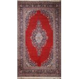 A CarpetA Carpet, wool yarn, polychrome decoration "Fleuron and vegetalist motifs" on burgundy