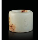 A jade and russet archer ring, China, 1900s - H 3cm -