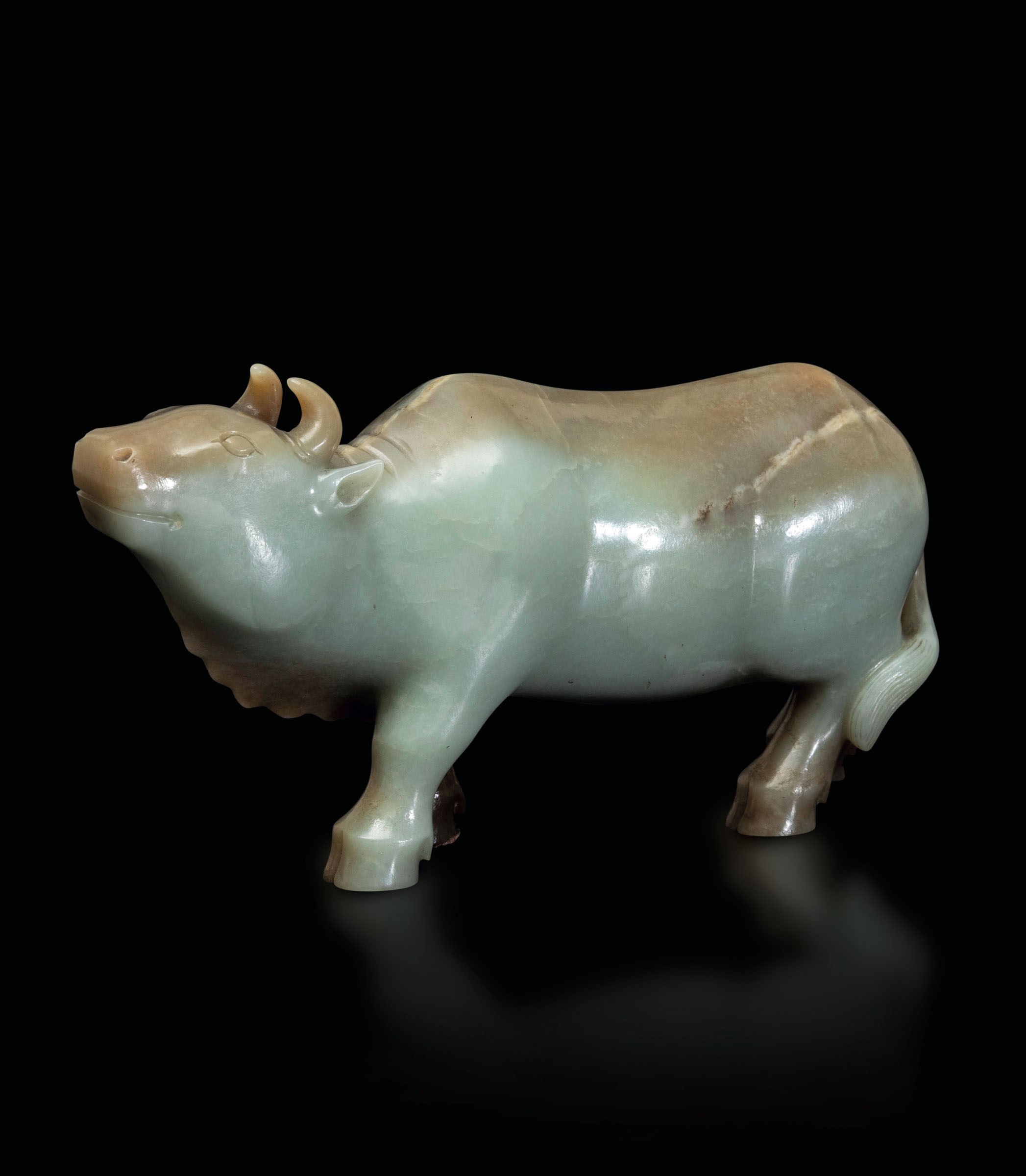 A Celadon jade and russet ox, China, Qing Dynasty - 18th-19th century. 10x20cm -