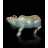 A Celadon jade and russet ox, China, Qing Dynasty - 18th-19th century. 10x20cm -