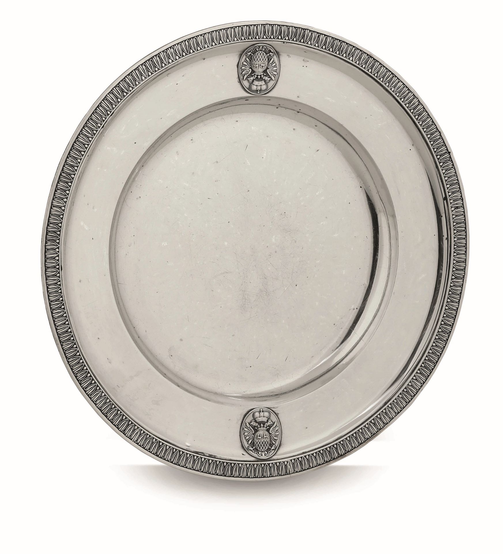 A silver plate, J. Reiner, Vienna 1856 - Molten and chiselled silver. 919gr, diam 22cm -