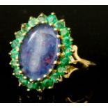 An Opal and Emerald Ring, Modern, in 9ct gold mount, set with an oval opal, approximately 10mm x