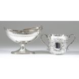 A George III Silver Oval Sugar Basket and a George V Silver Two-Handled Cup, the sugar basket by