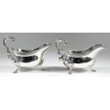 A Pair of Victorian Silver Oval Sauce Boats, by Robert Garrard, London 1875, with gadroon mounts and