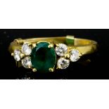 An Emerald and Diamond Ring, Modern, in 18ct gold mount, set with central oval emerald,