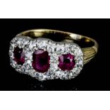 A Ruby and Diamond Cluster Ring, Modern, in gold coloured metal mount, set with three oval rubies,