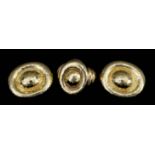 A 22ct Gold Ring and Pair of Matching Earrings, Modern, of moulded oval form with hammered finish,