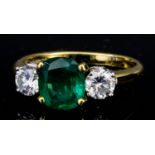 A Three Stone Emerald and Diamond Ring, Modern, in 18ct gold mount, set with central emerald,