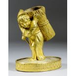 An Ormolu Taper Holder Modelled in the Form of a Cloaked Putto Carrying a Sheaf of Corn, 19th