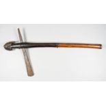 An Ethnic Axe, Early 20th Century, 11ins iron blade, native worked shaft with carved head to top,