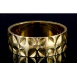 An 18ct Gold Wedding Band, with punched leaf ornament, size M, weight 4.3g