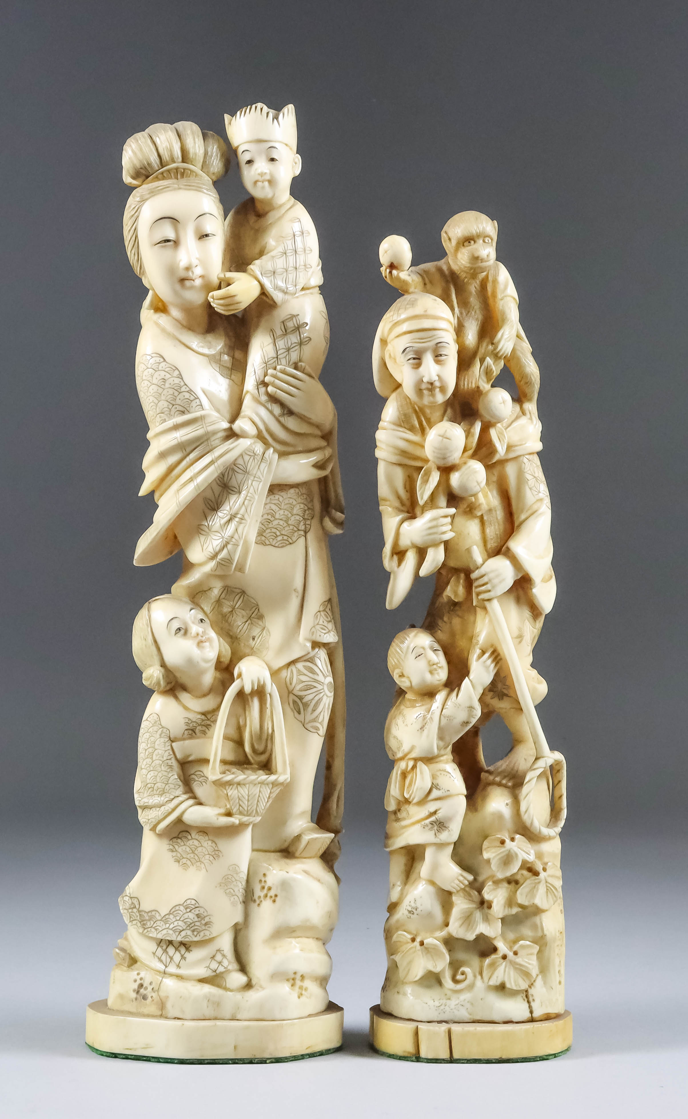 A Japanese Carved Ivory Okimono, Meiji Period, of a standing woman, with a child in her arms with