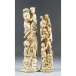 A Japanese Carved Ivory Okimono, Meiji Period, of a standing woman, with a child in her arms with