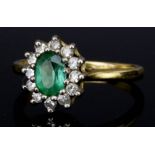 A Peridot and White Sapphire Oval Cluster Ring, 20th Century, in 18ct gold mount, set with central